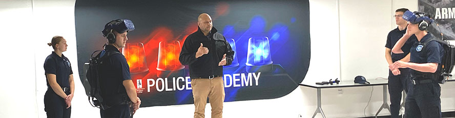 An NMC Police Academy law enforcement program instructor leads a training session with students uses VR goggles