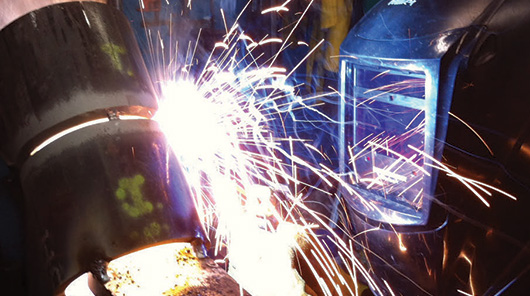 An NMC welding program student welds a pipe