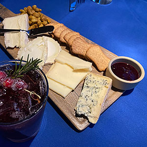 A cocktail and charcuterie tray