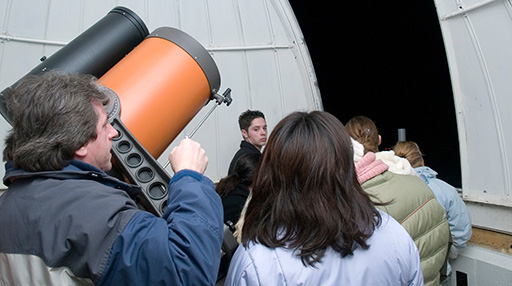 Astronomy instructor Jerry Dobek and students at the telescope