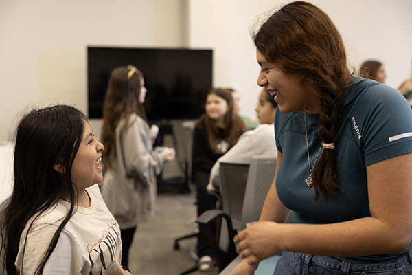 A Blair Elementary student and mentor laugh