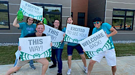 NMC students with welcome banners 