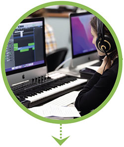 Photo of an NMC audio tech student wearing headphones and working on a laptop