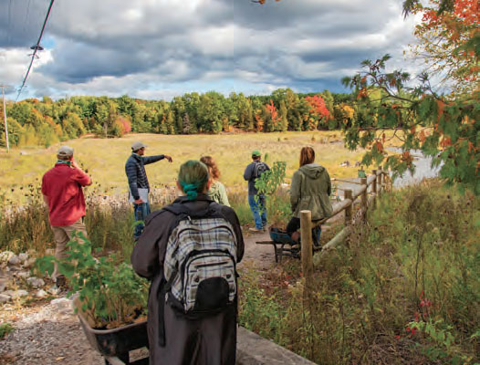 Freshwater studies students plant trees with the Grand Traverse Conservation District by the Boardman River.