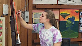 An NMC Fine Arts program student painting