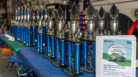 Trophies lined up for prize winners of the 2026 Mike McIntosh Truck & Car Show