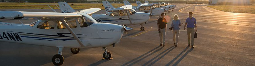 NMC Aviation airplanes and students at sunset