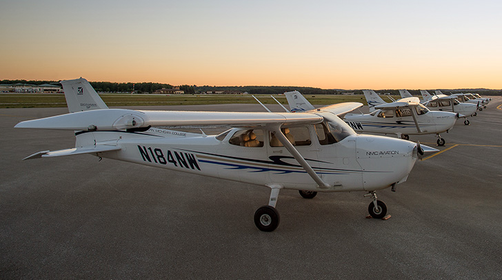 NMC Aviation program planes lines up on the runway at sunrise