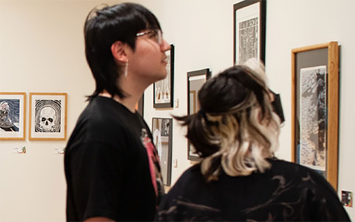 Students look at paintings at the Dennos Museum Center