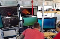 Great Lakes Water Studies Institute student monitors underwater camera feeds