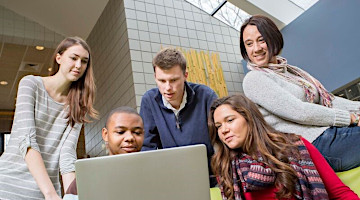 Academic students looking at computer
