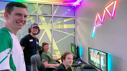 Four NMC Varsity Esports program team members in the esports lab